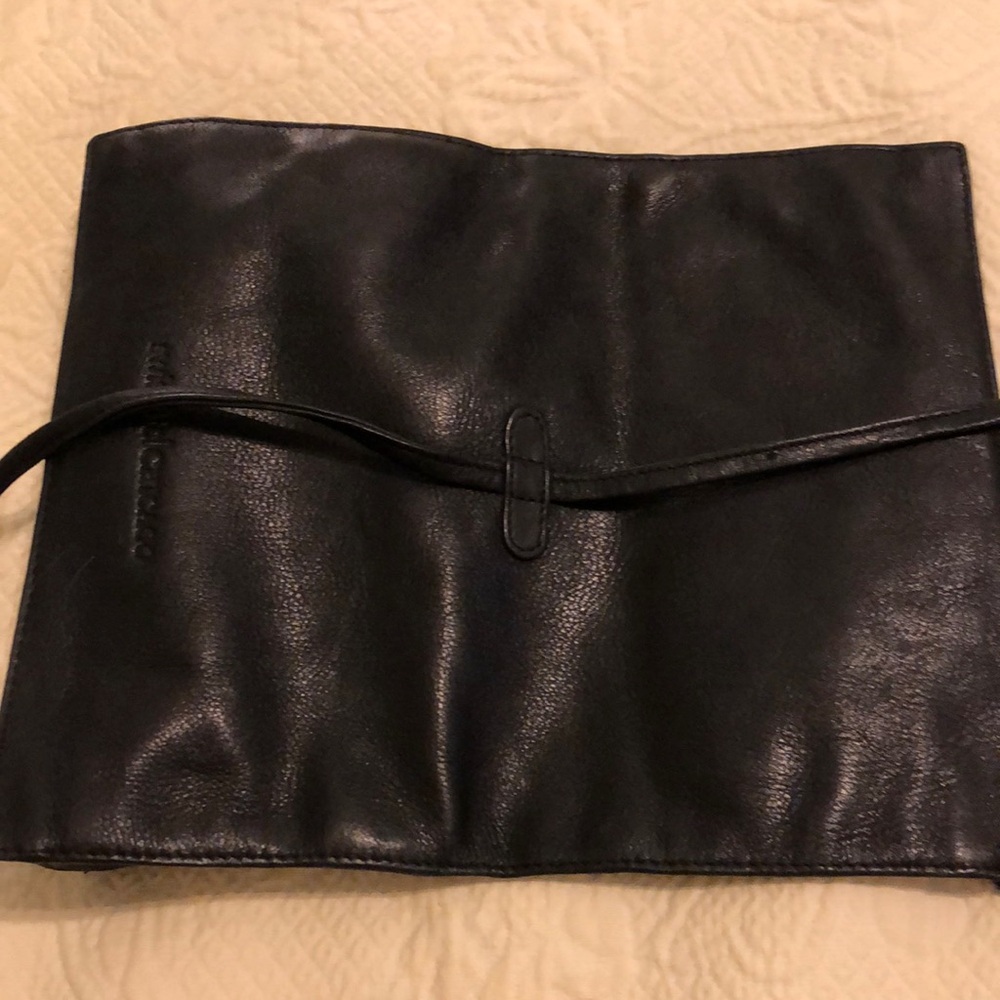 Black leather jewelry roll. Swissotel logo embossed in black. EUC.
